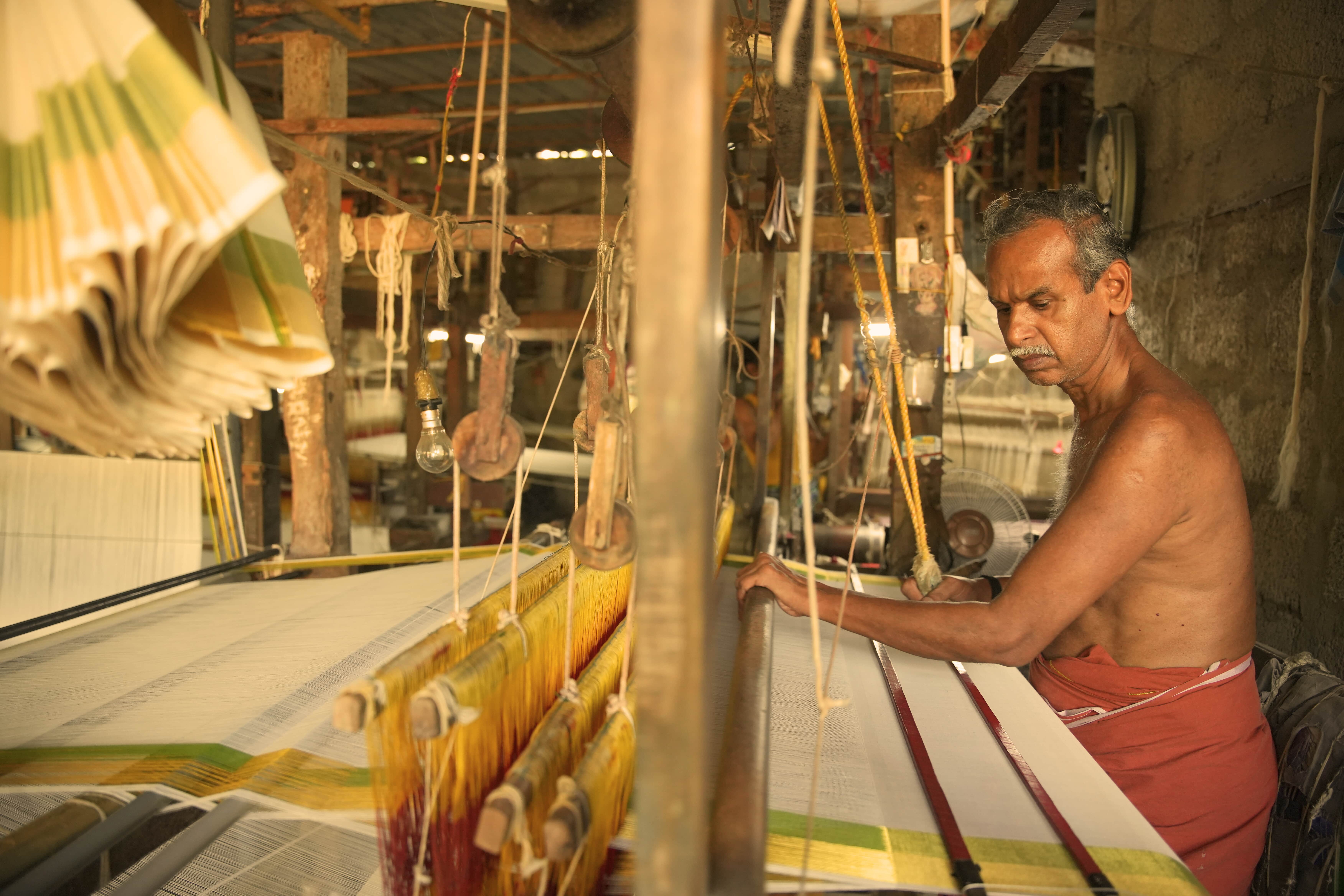 Master weaver at traditional pit loom