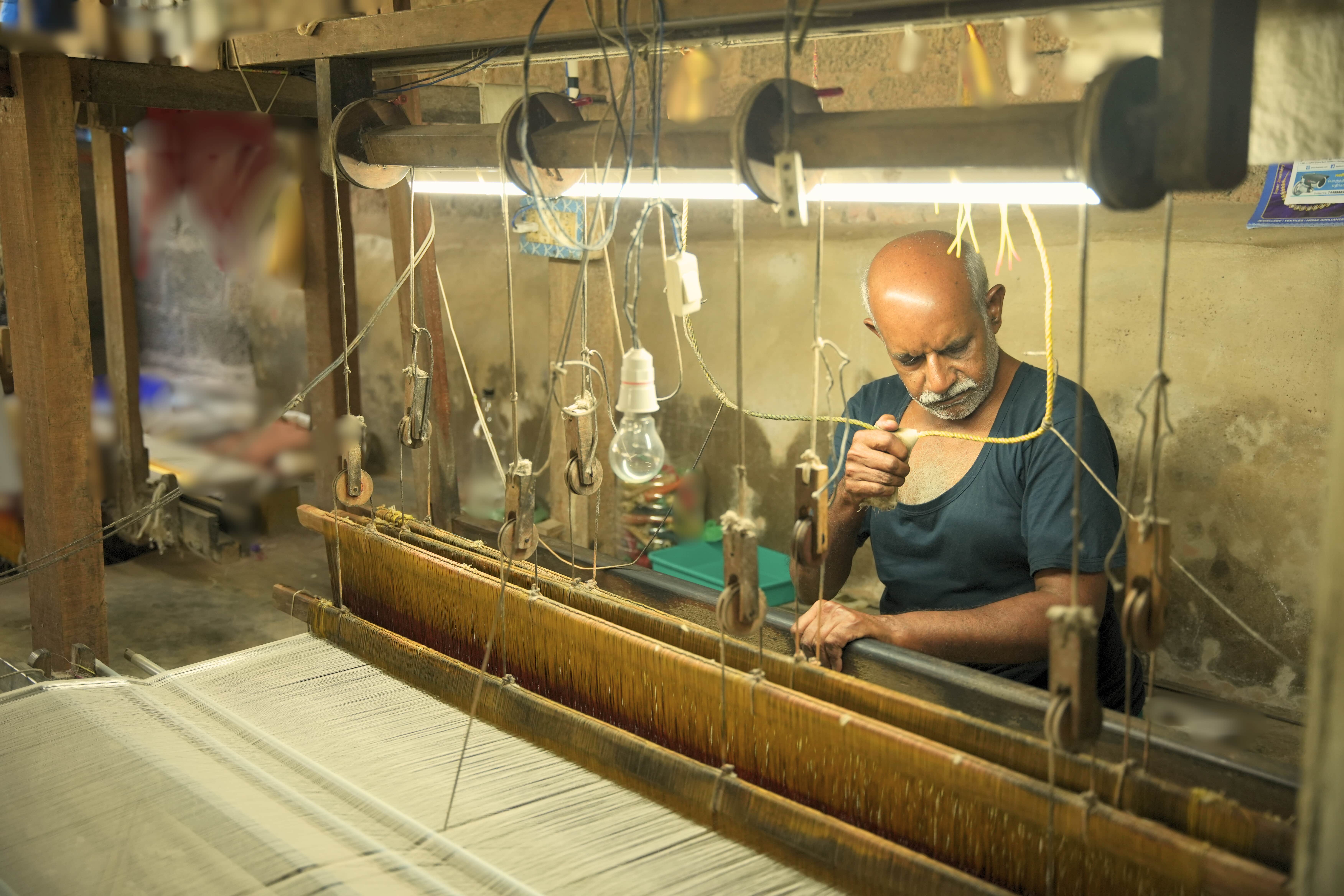 Artisan preparing loom threads